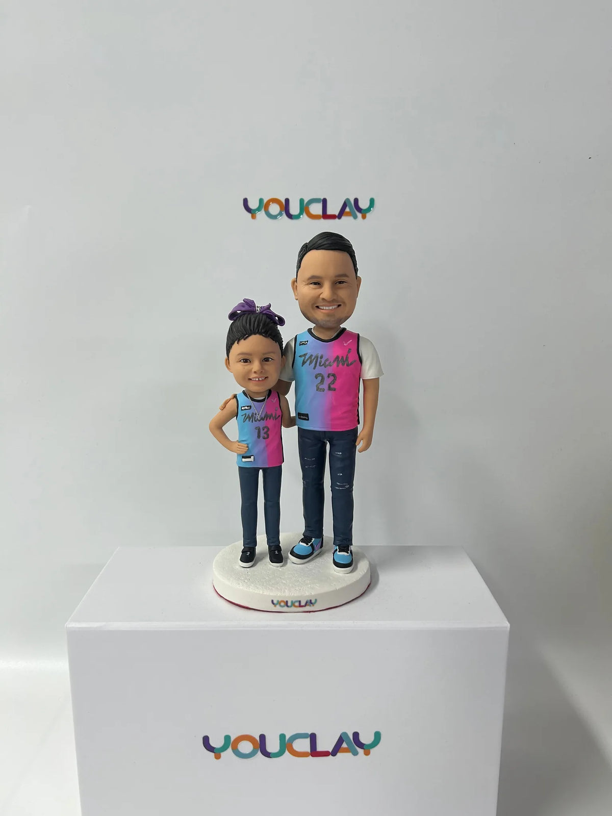 Dad and young daughter in matching Miami basketball jerseys, a father-daughter custom bobblehead
