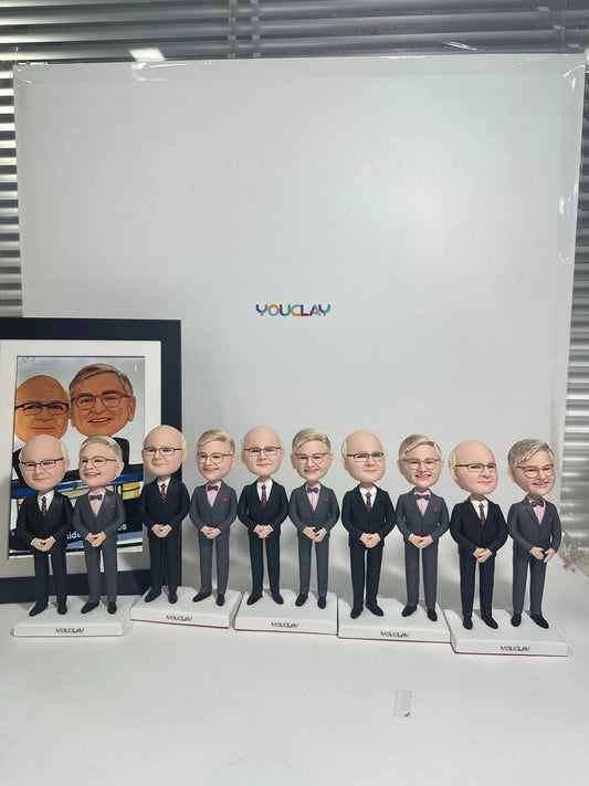 Ten men in matching gray suits on separate bases, sculpted from a framed office photo
