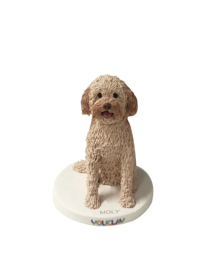 Sitting cream doodle with curly fur and tongue out, a pet portrait figurine with the name Moly on the base